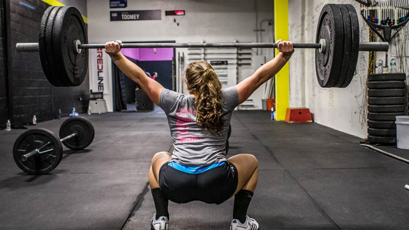 CrossFit female athlete performing overhead squat