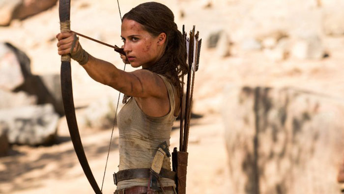 Alicia Vikander shooting bow and arrow as Lara Croft from Tomb Raider