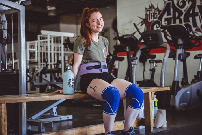 woman doing strength training smiling
