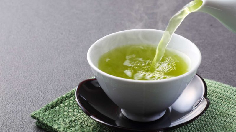 green tea being poured into a cup