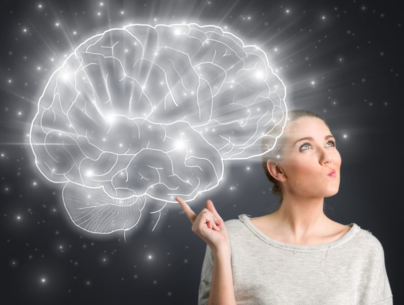 woman with drawing of a light up brain to indicate an idea and nootropic brain power